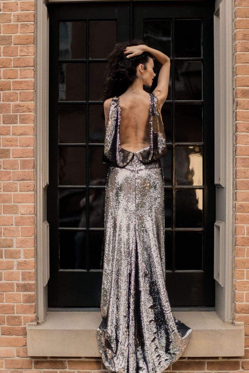 Open-back silver sequin gown against black French doors and red brick, Old Town Alexandria engagement session.